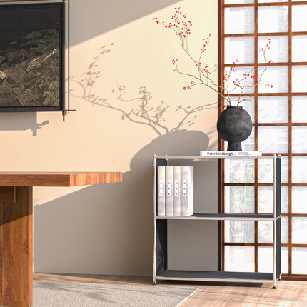 Modern metal sideboard with open shelves beside wooden table and shoji-style window in sunlit room
